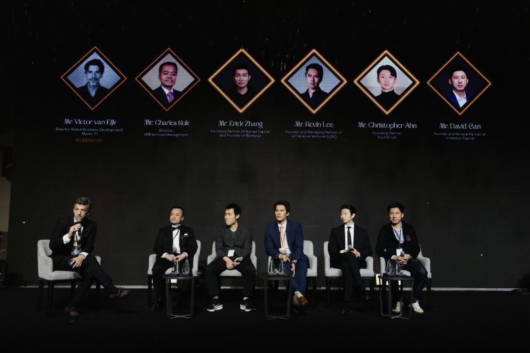 Panel discussion at BNB 1K Gala Night featuring moderator Victor van Eijk and panelists Charles Kok, Erick Zhang, Kevin Lee, Christopher Ahn, and David Gan seated on stage.