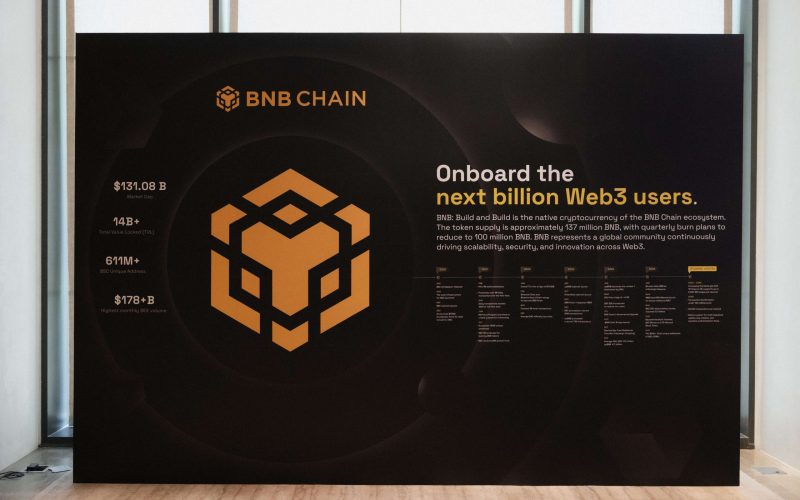 Large black and gold BNB Chain infographic display board titled "Onboard the next billion Web3 users," showcasing key ecosystem statistics, timeline milestones, and the BNB logo.